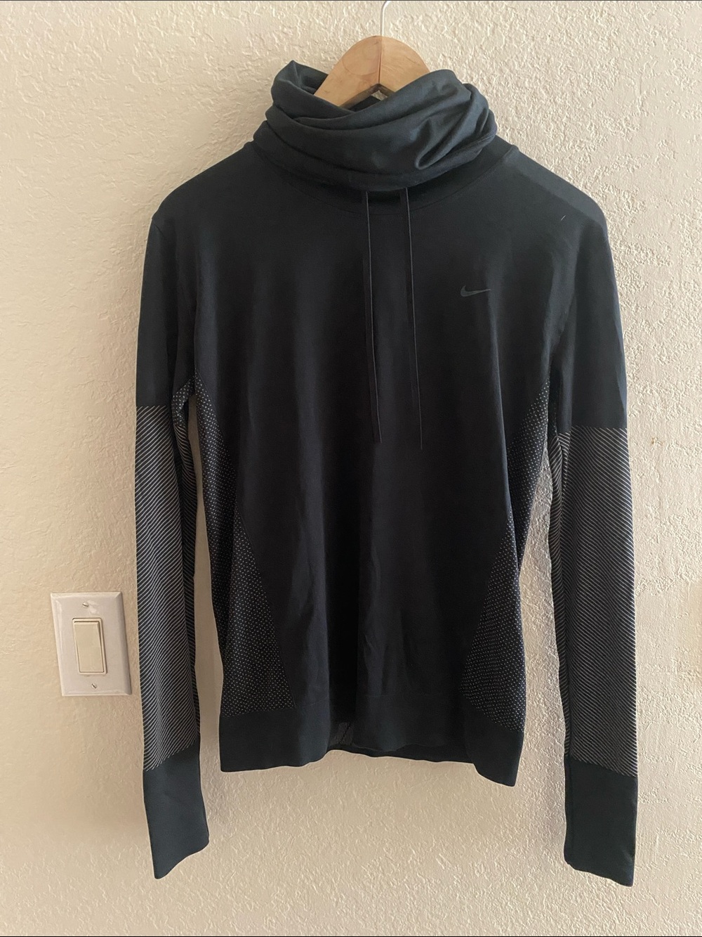 Nike women’s Black Turtleneck Pullover with Textured Sleeve Panels